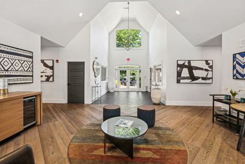 A living room with a rug and a coffee table.
